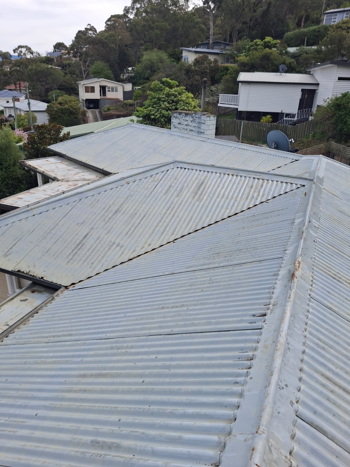 Corrugated iron roof before painting — weathered and rusted