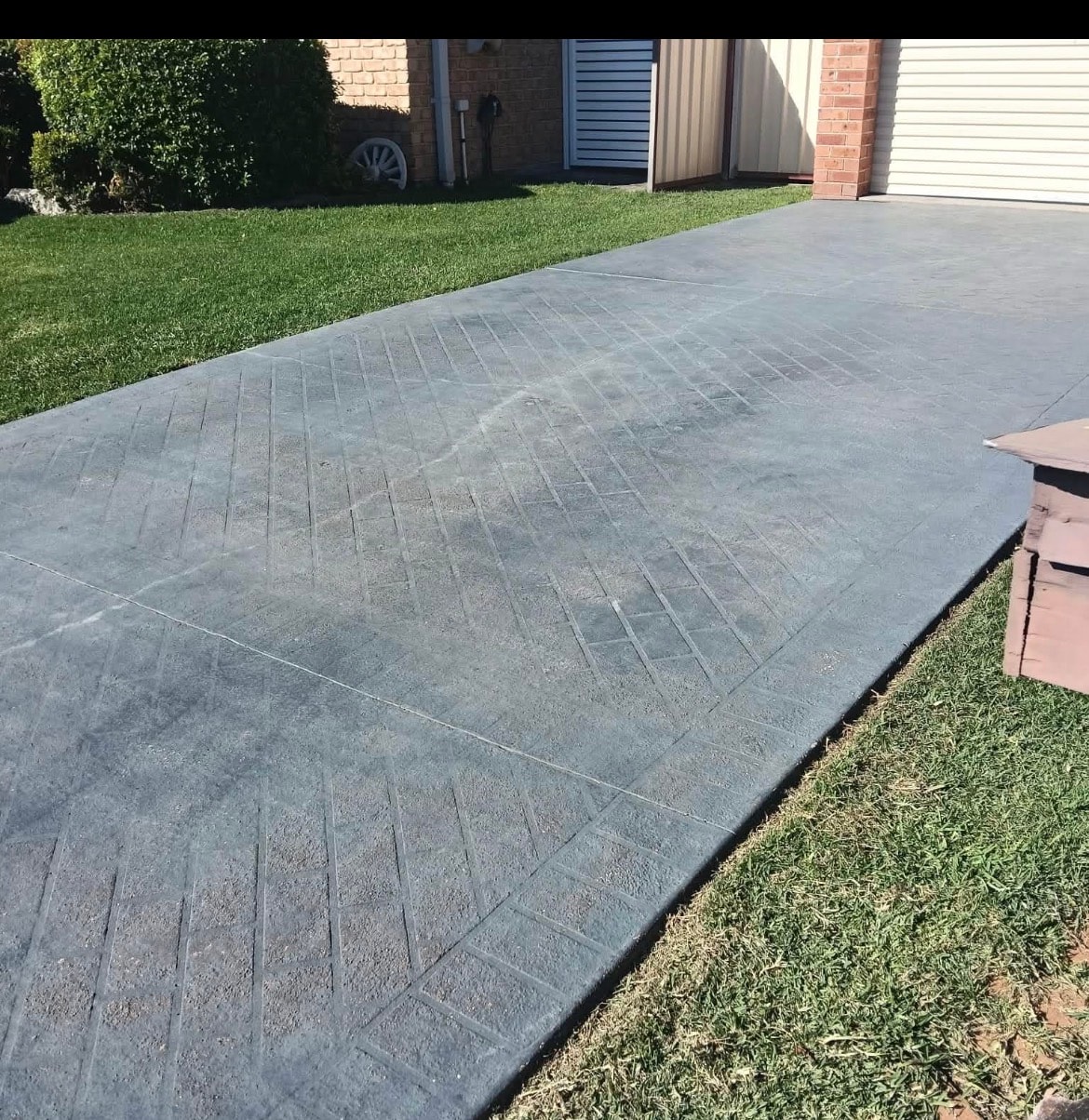 Stamped concrete driveway before painting — residential property